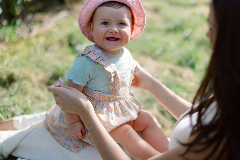 \little girl sits on her mother's lap