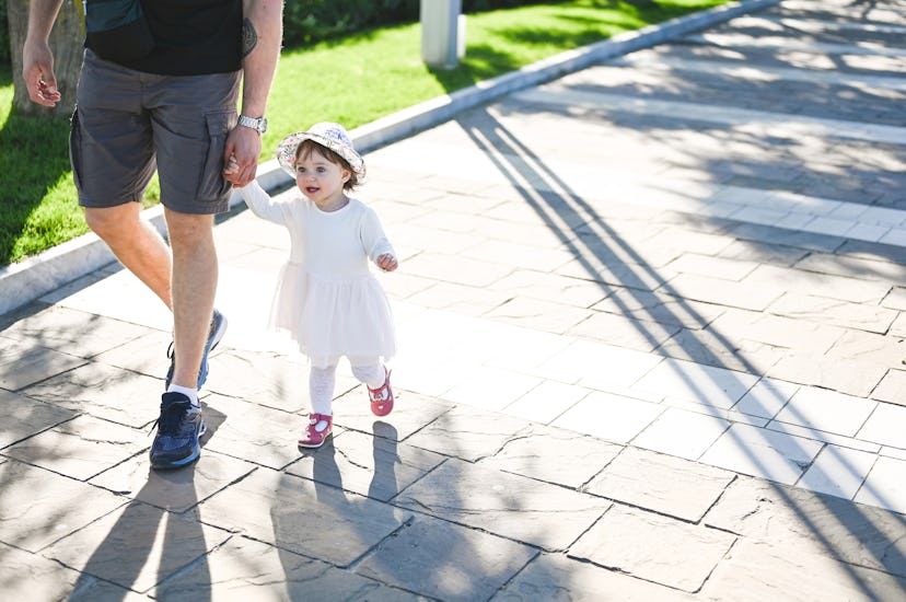 little girl walking with dad