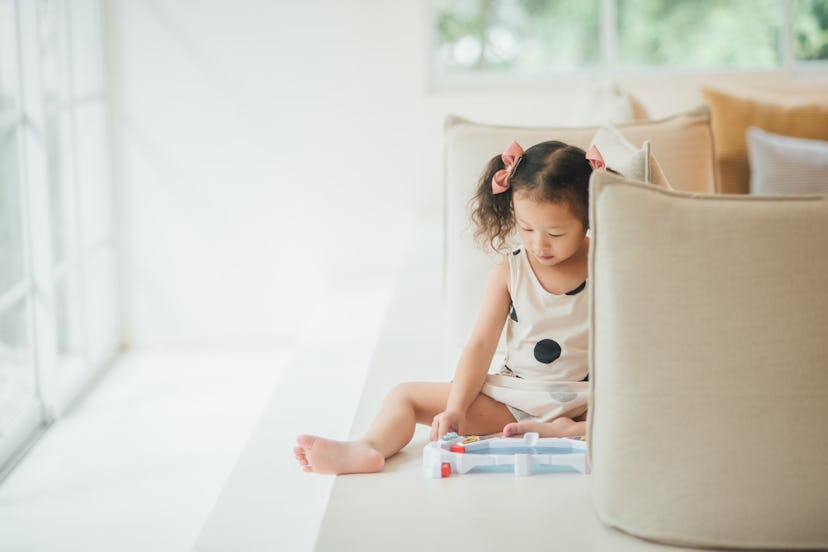 little girl engaging joyfully with a board game