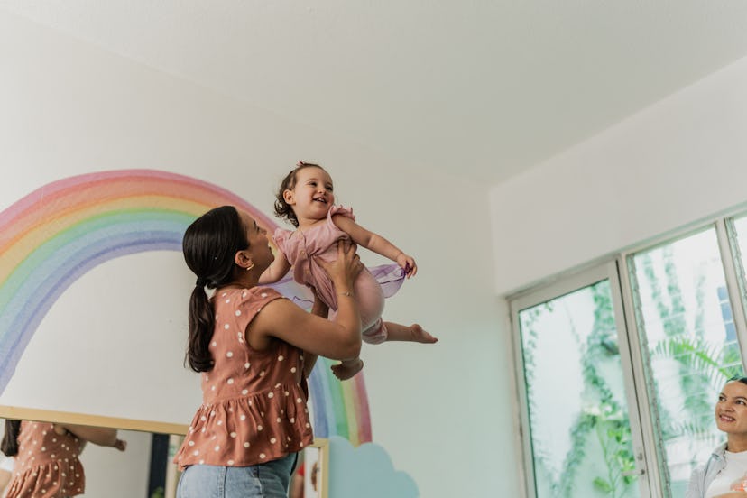  mother playing with her daughter in playroom