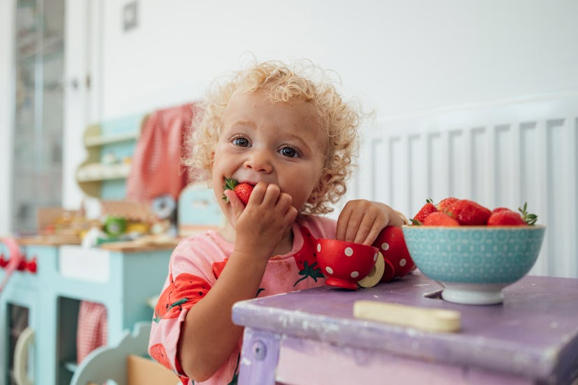  female toddler eating strawberries 