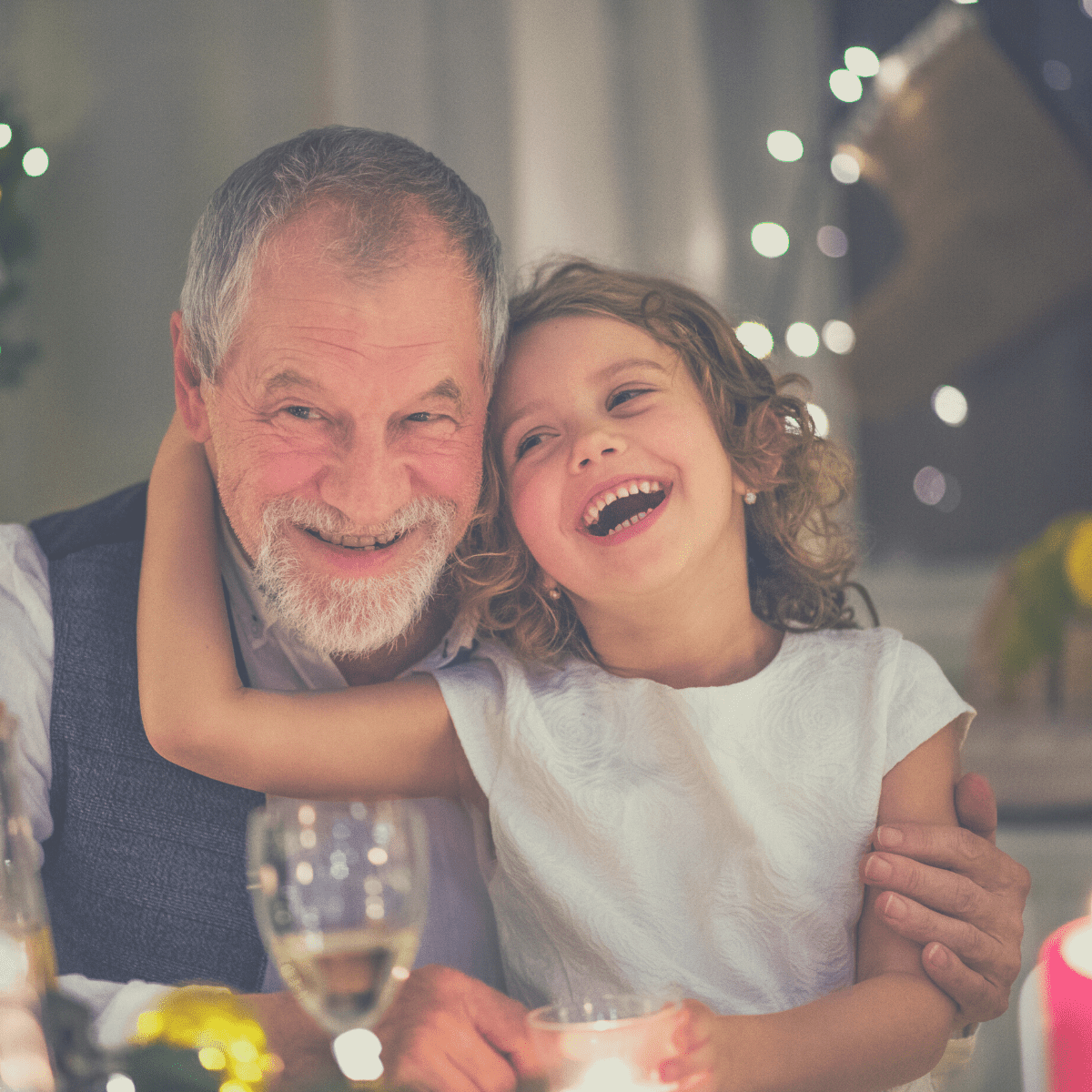 A grandpa and granddaughter playing Would You Rather Christmas at the holiday dinner table.