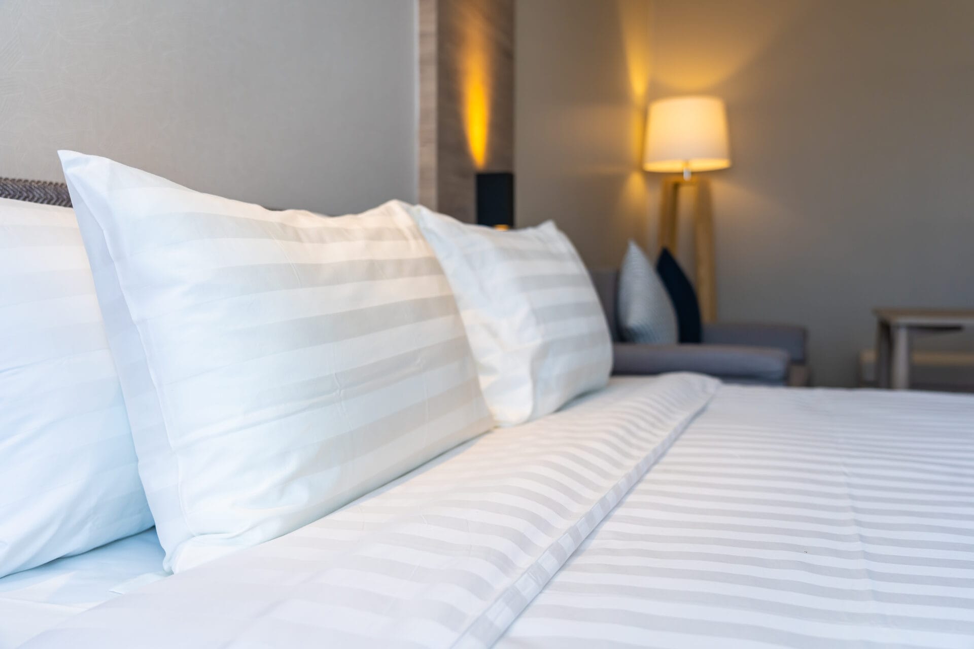 White comfortable pillow on bed decoration interior of bedroom