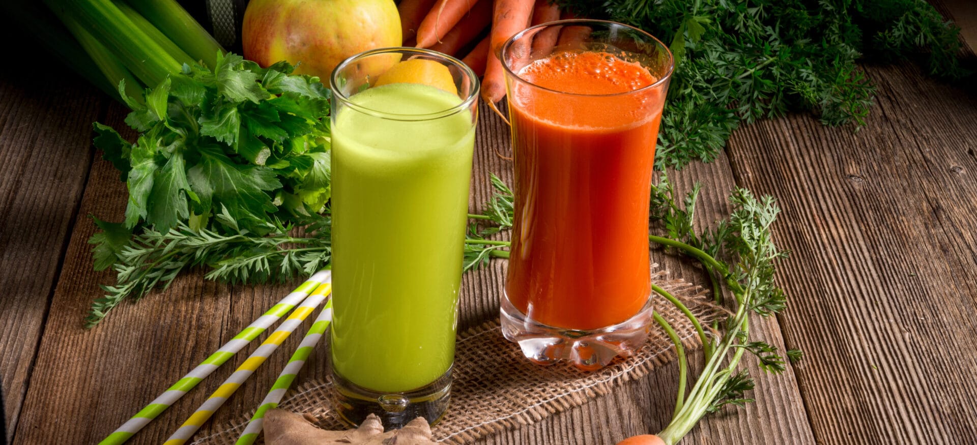 celery and carrot juice sitting on a hardwood table