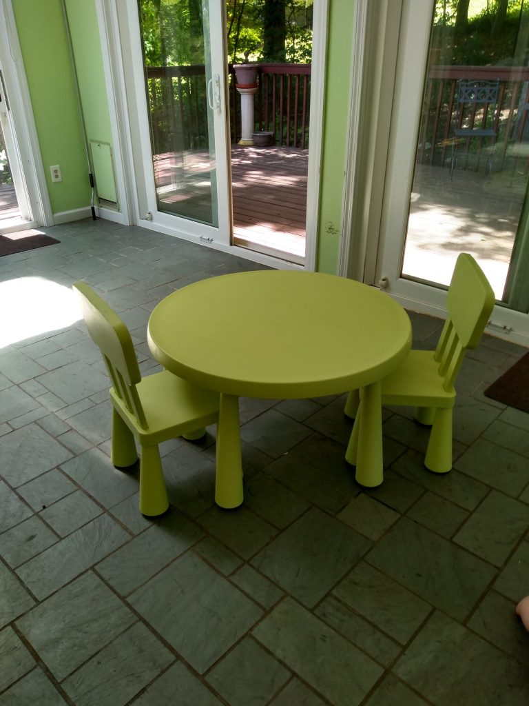 Kids sized ikea kids table in empty Montessori playroom.