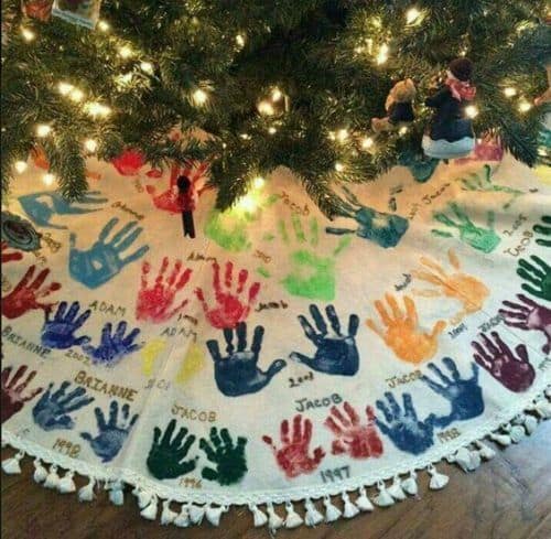 Christmas tree skirt with children\'s hand prints.