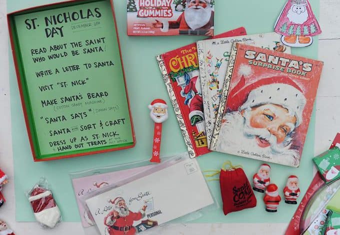 A stack of Christmas books and prizes on a table