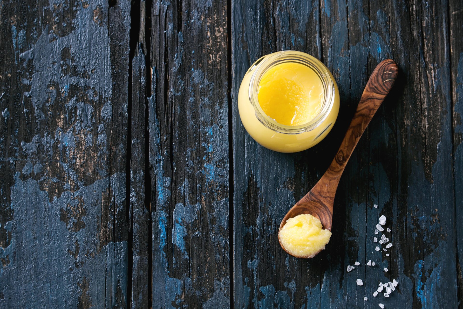 Ghee in a wooden spoon on a table