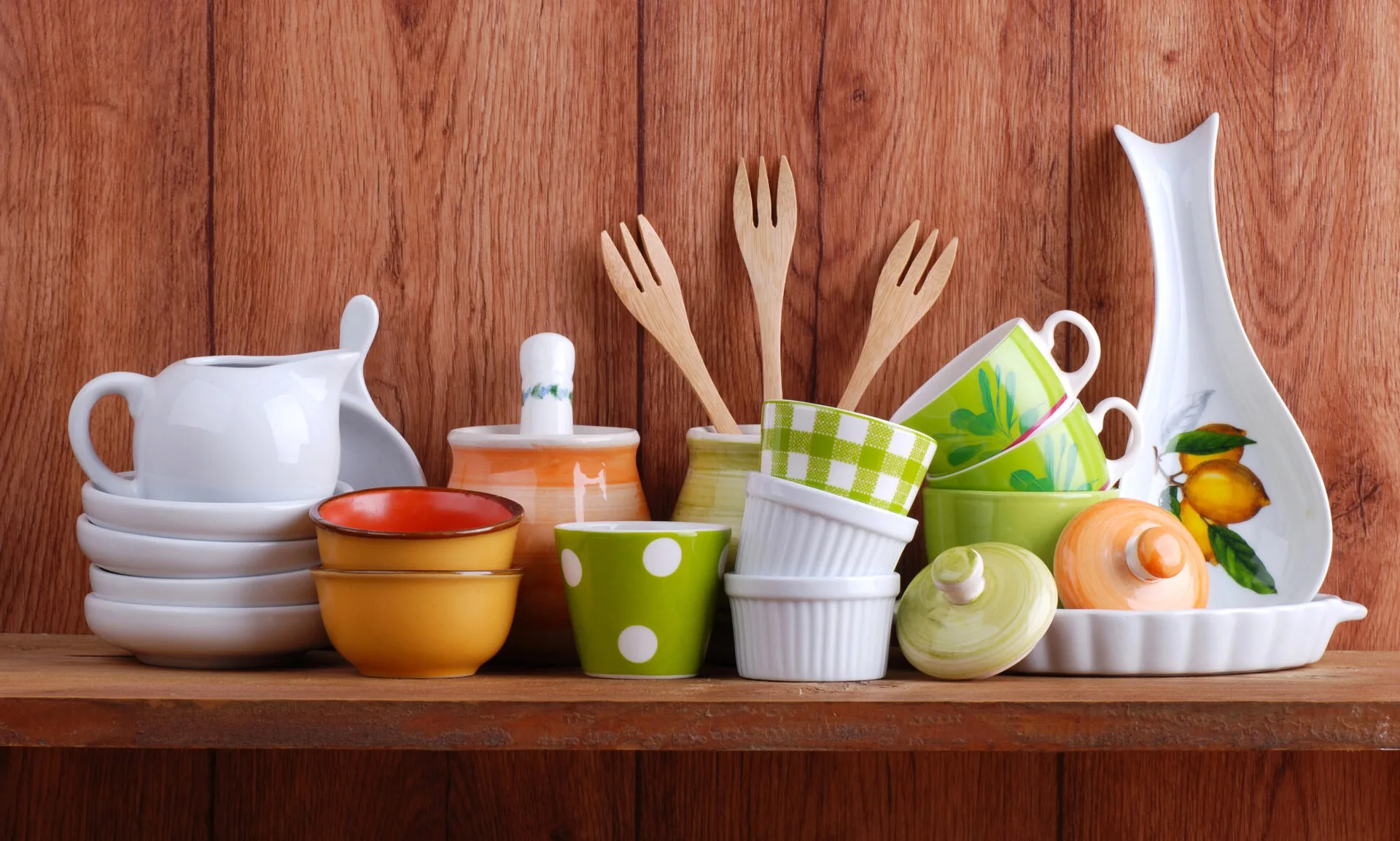 Kitchen utensils like ramekins, wooden spoons, and bowls made from ceramic