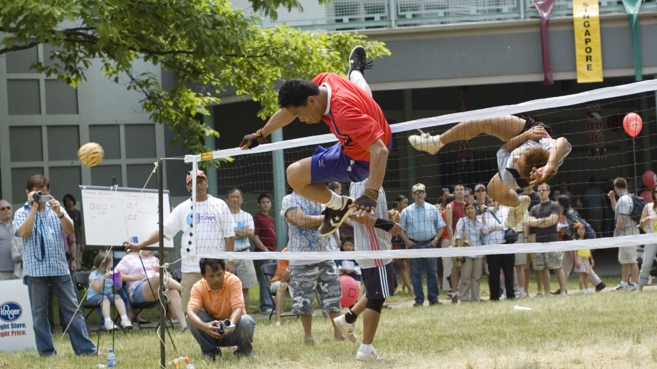 Two players jumping in a Sepak Takraw game