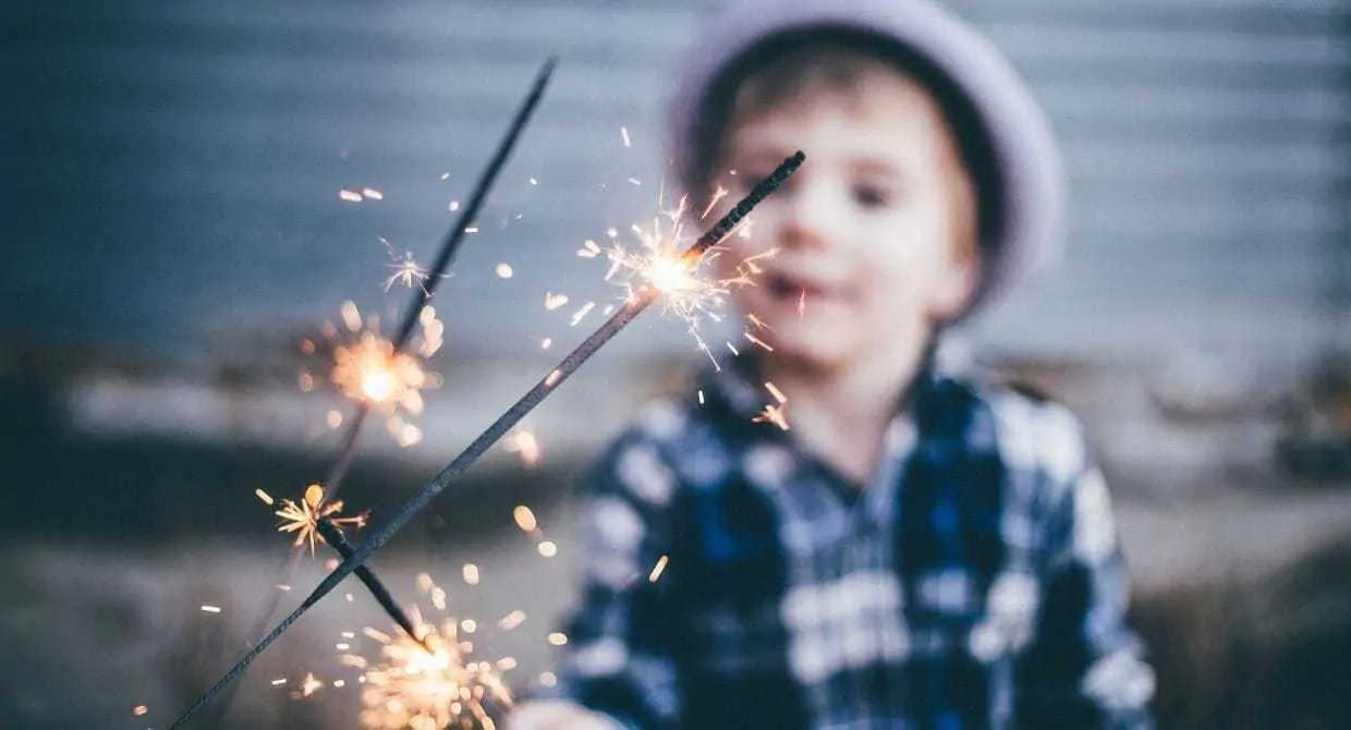 Little boy holding sparklers