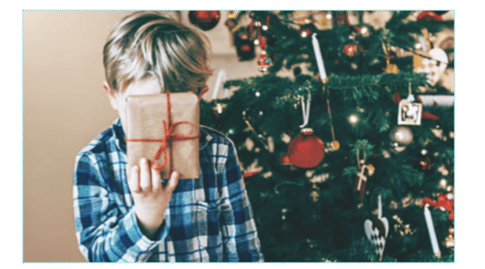 Child holding one of the 4 christmas gift idea