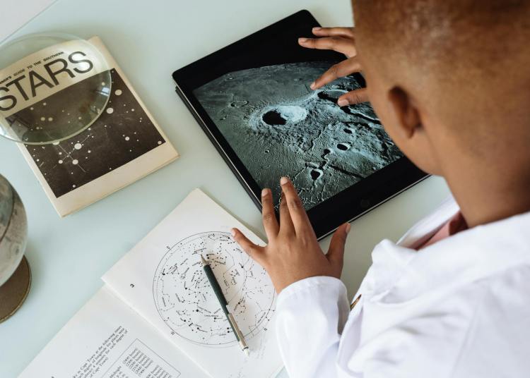 african american boy searching on a teh device learning about digital footprints