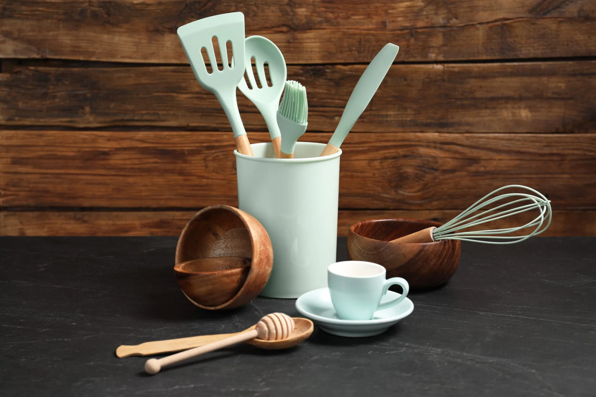 Set of different kitchen utensils on grey table